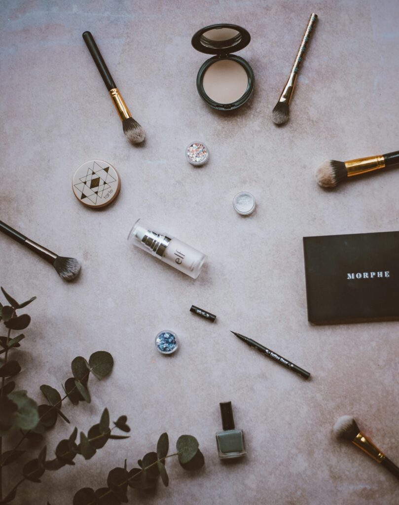 An assortment of makeup palettes laid out on a soft surface