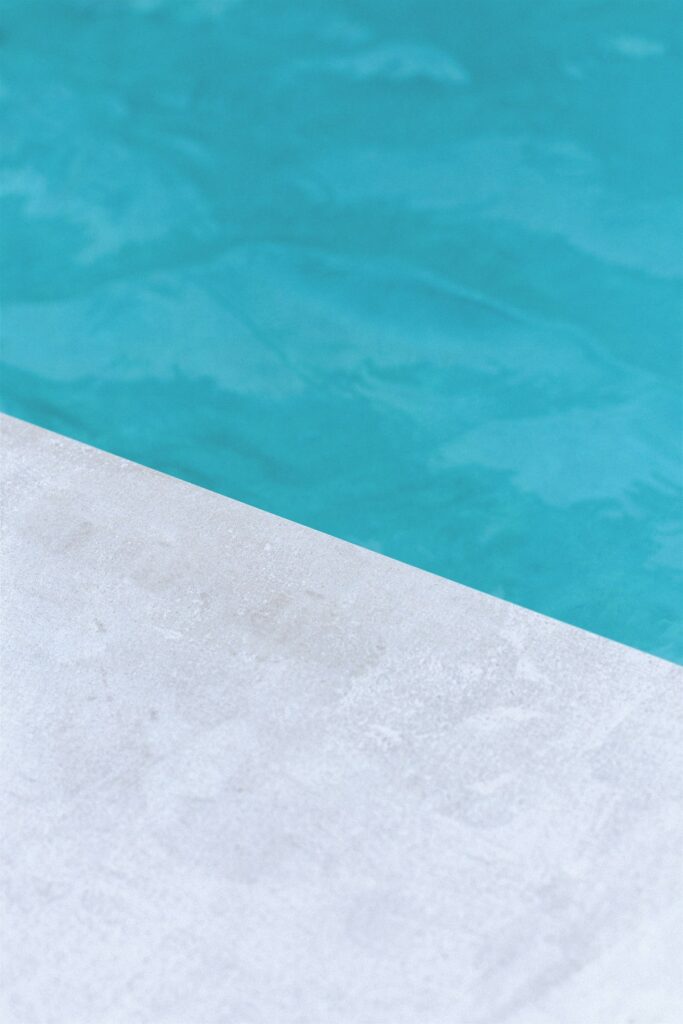 A poolside summer scene with sunshine