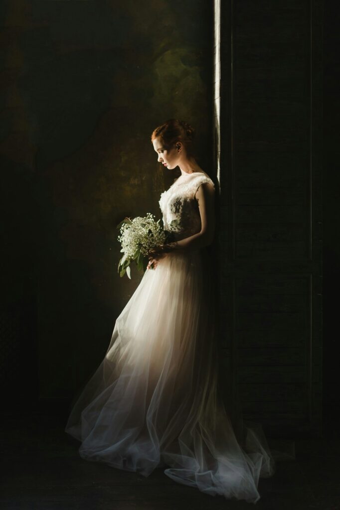 A bride in a white wedding gown holding a bouquet