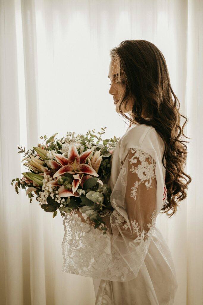 A bride in a white wedding gown holding a bouquet