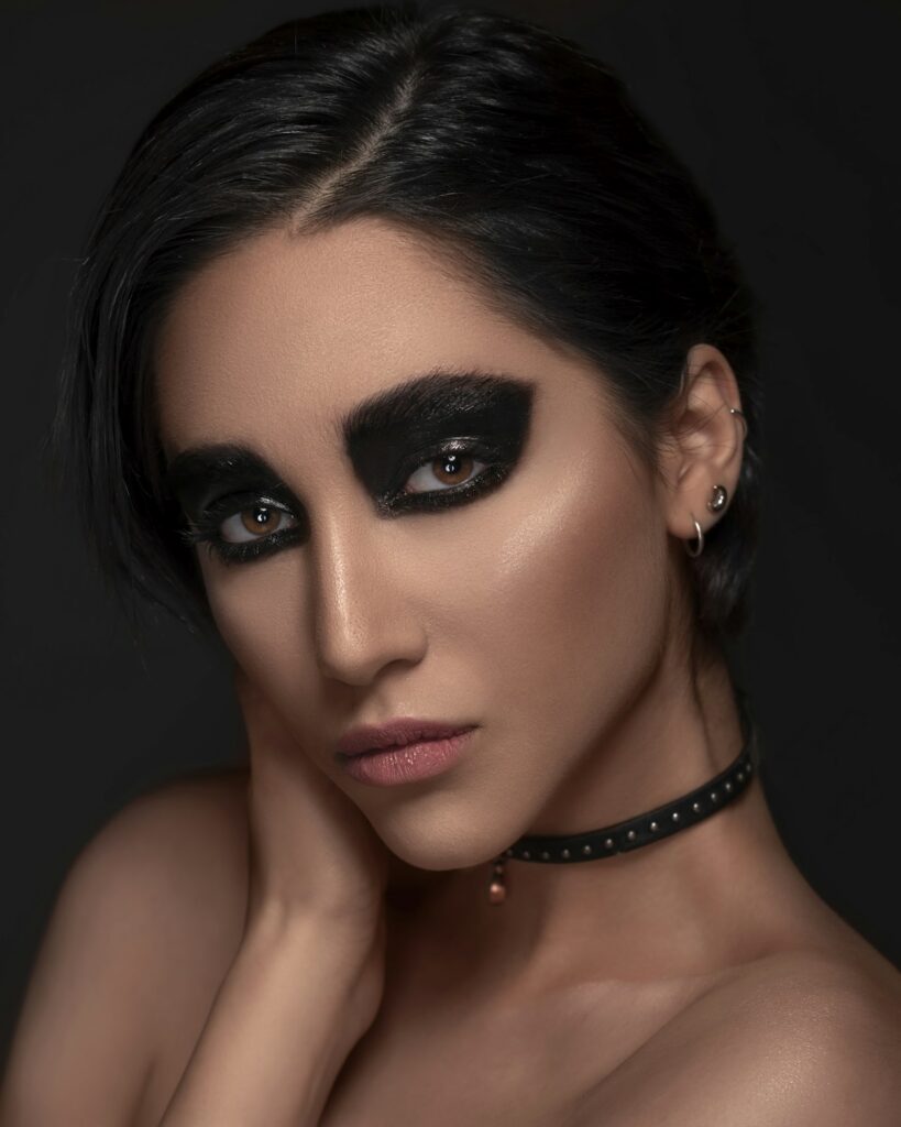 Close-up of a woman with a smoky eye and pink lipstick