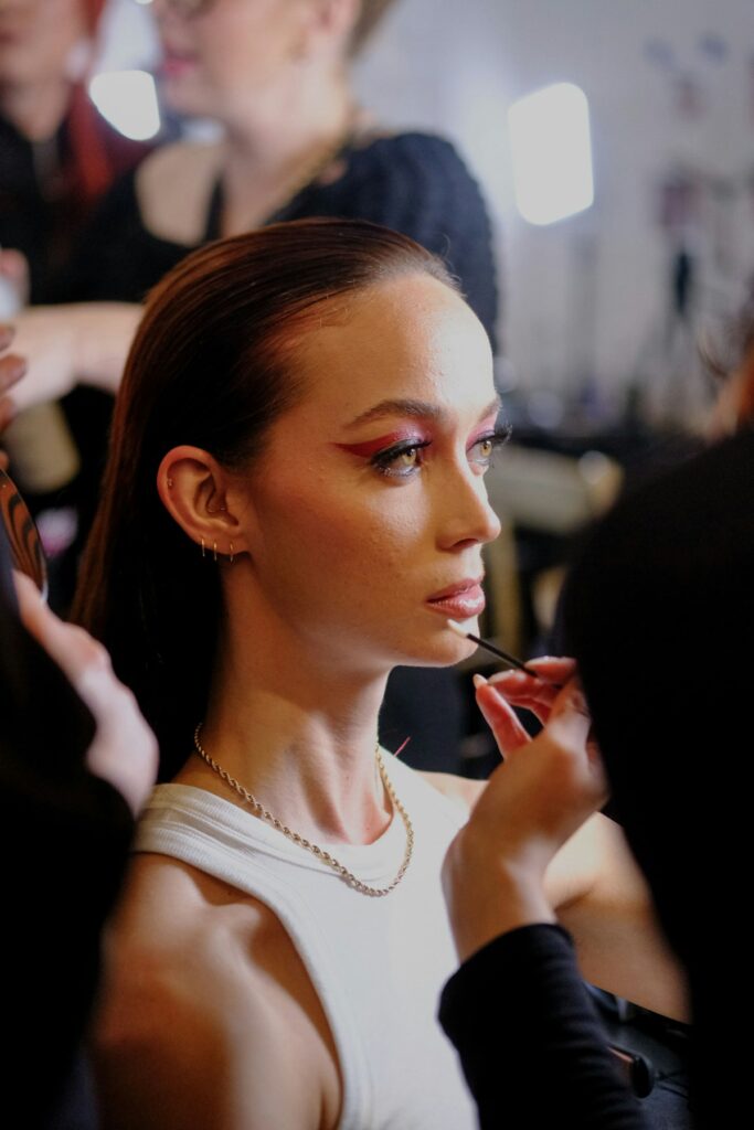A woman getting her makeup done by a professional makeup artist