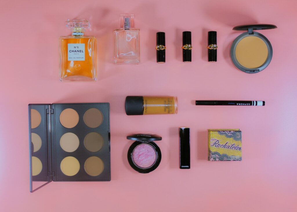 Skincare and makeup arranged on a soft surface in early-fall light