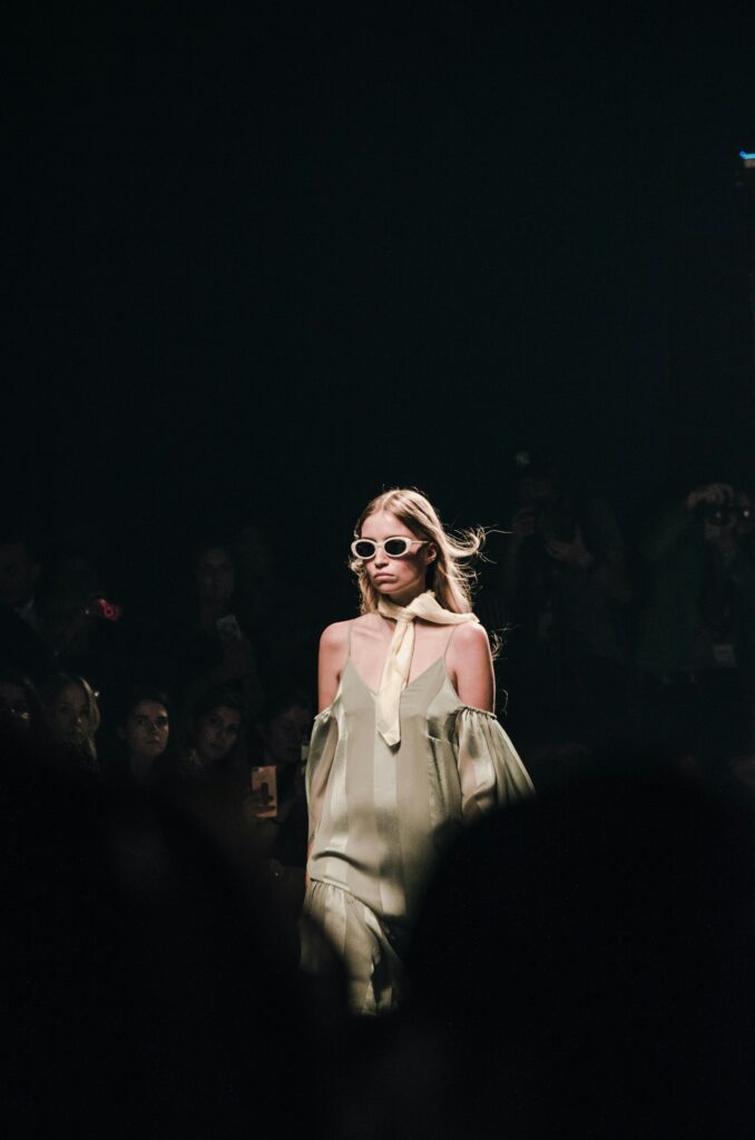 Fashion week model on a clean runway in soft daylight