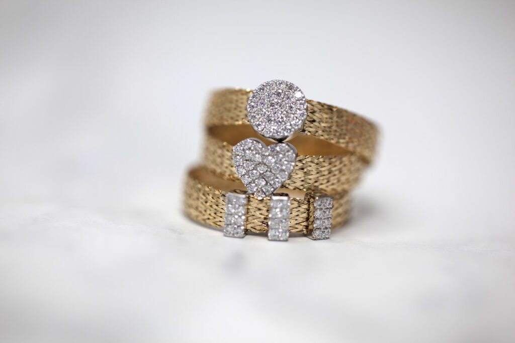 Three small gold-coloured studded rings