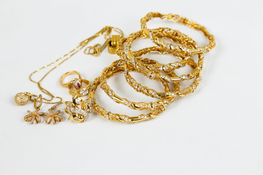 Gold rings and chains arranged on a soft surface
