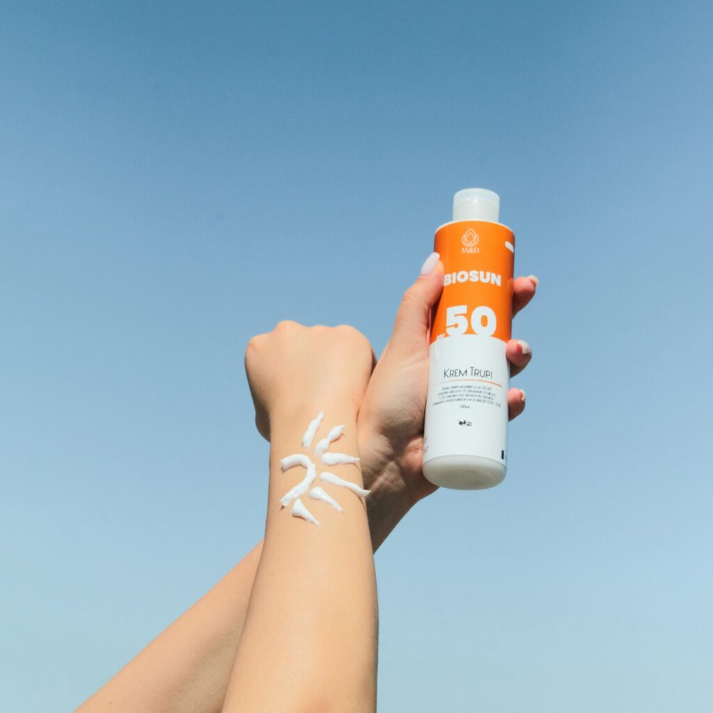 Sunscreen tube and skincare on a bright surface