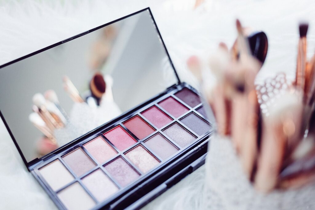 Bridal makeup vanity with brushes and palettes in soft light