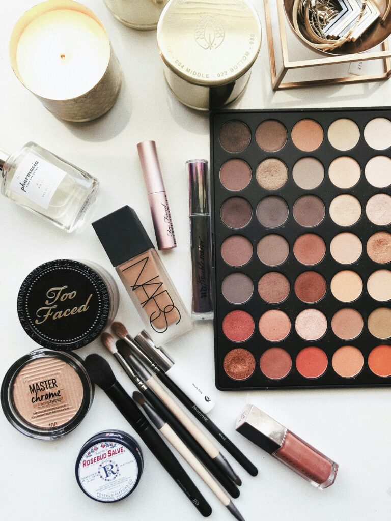 Beauty products and floral details on a cream backdrop