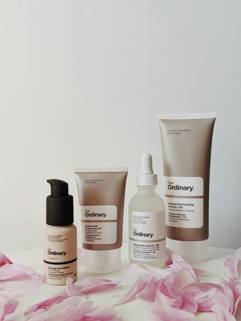 Spring beauty edit with pastel shades and bottles by a sunny window
