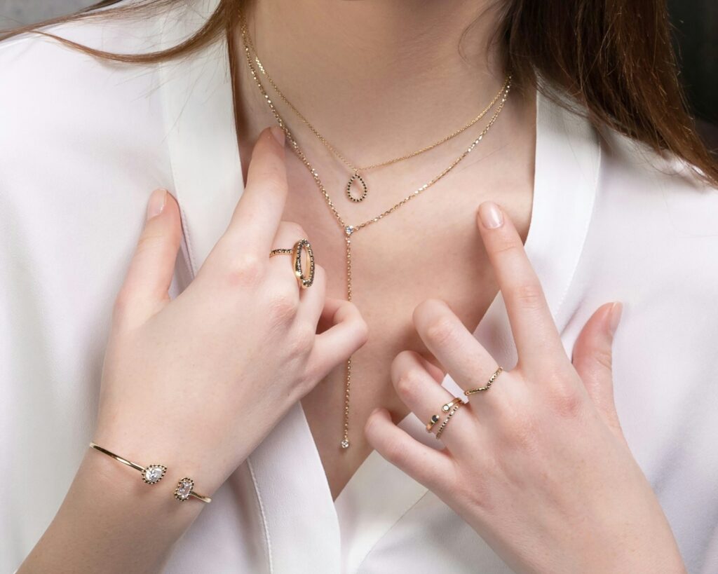 Stack of gold rings on a marble surface