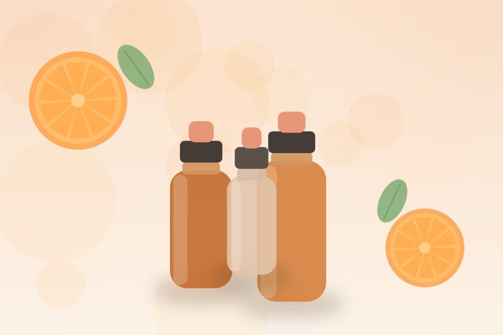 Amber and frosted-glass vitamin C serum dropper bottles with fresh orange slices on a soft peach background